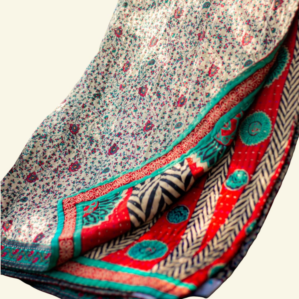 Folded fabric with floral and geometric patterns on a beige background