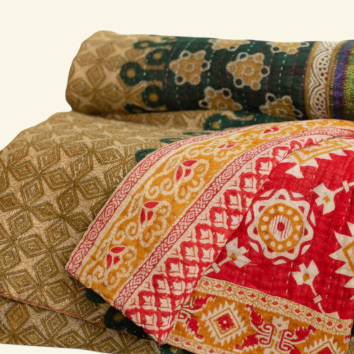 Stack of patterned blankets with a mix of colors on a beige background