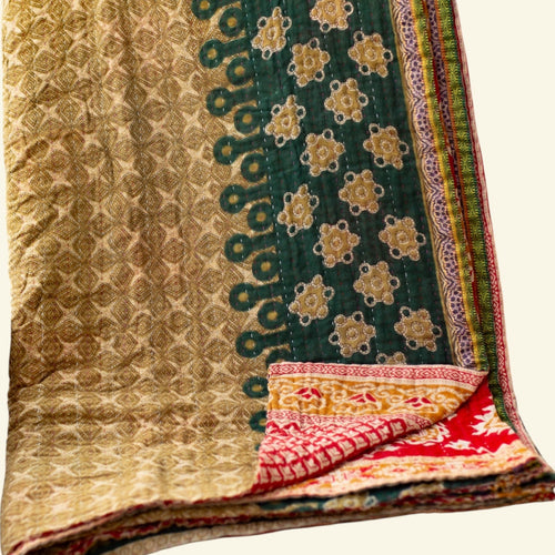 Colorful quilt with intricate patterns on a beige background