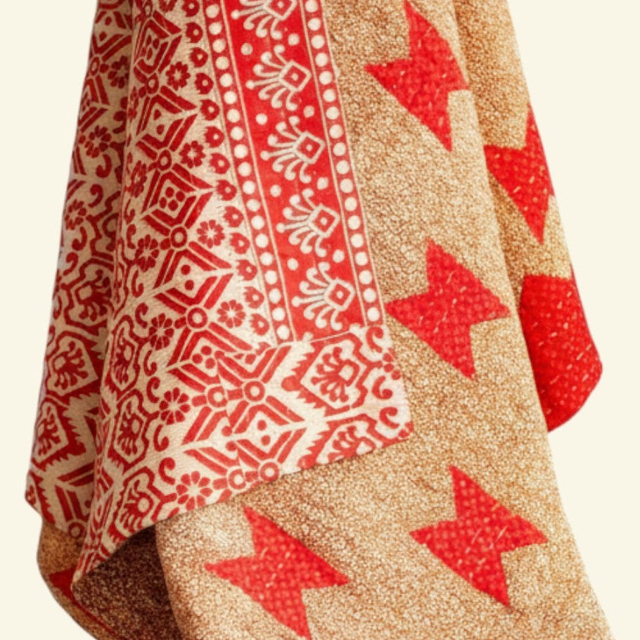 Textile with red star patterns on a beige background