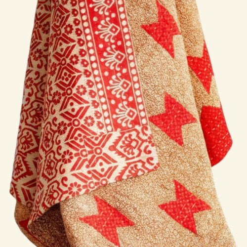 Textile with red star patterns on a beige background