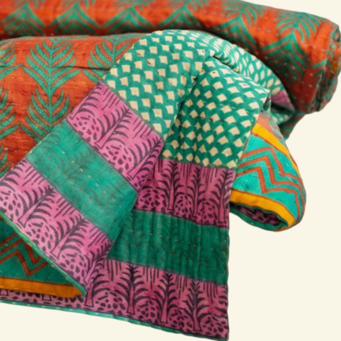 Colorful quilt with geometric patterns on a beige background