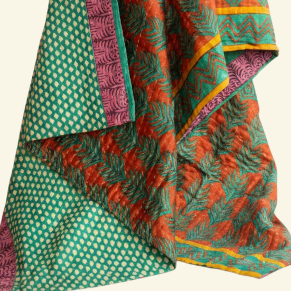 Colorful patterned fabric with green, red, and purple design on a beige background