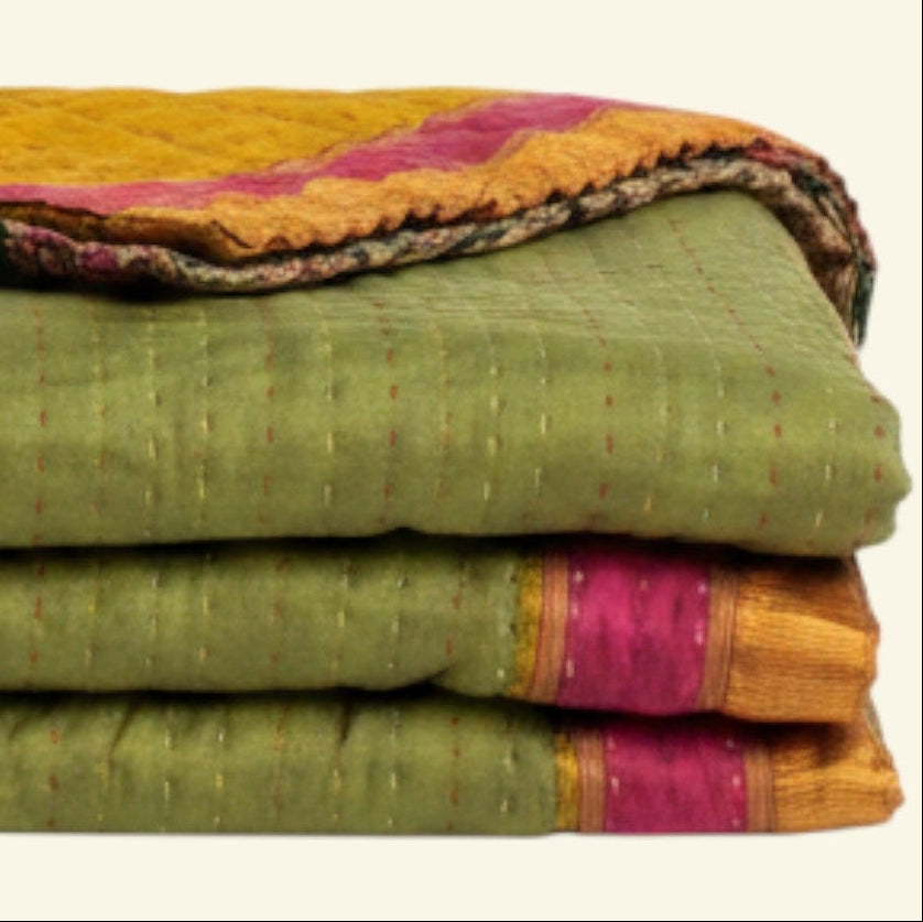 Stack of colorful folded fabrics on a beige background