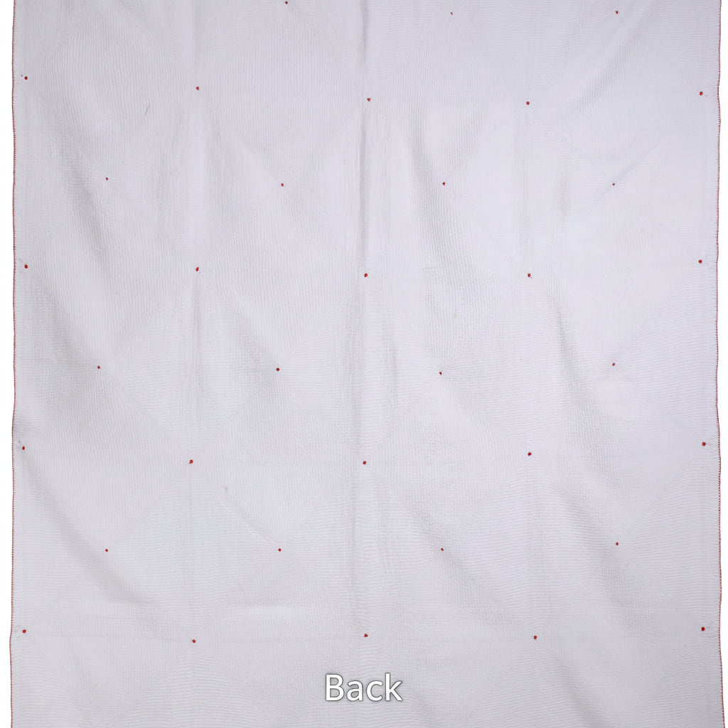 White blanket with small red and blue dots on a white background