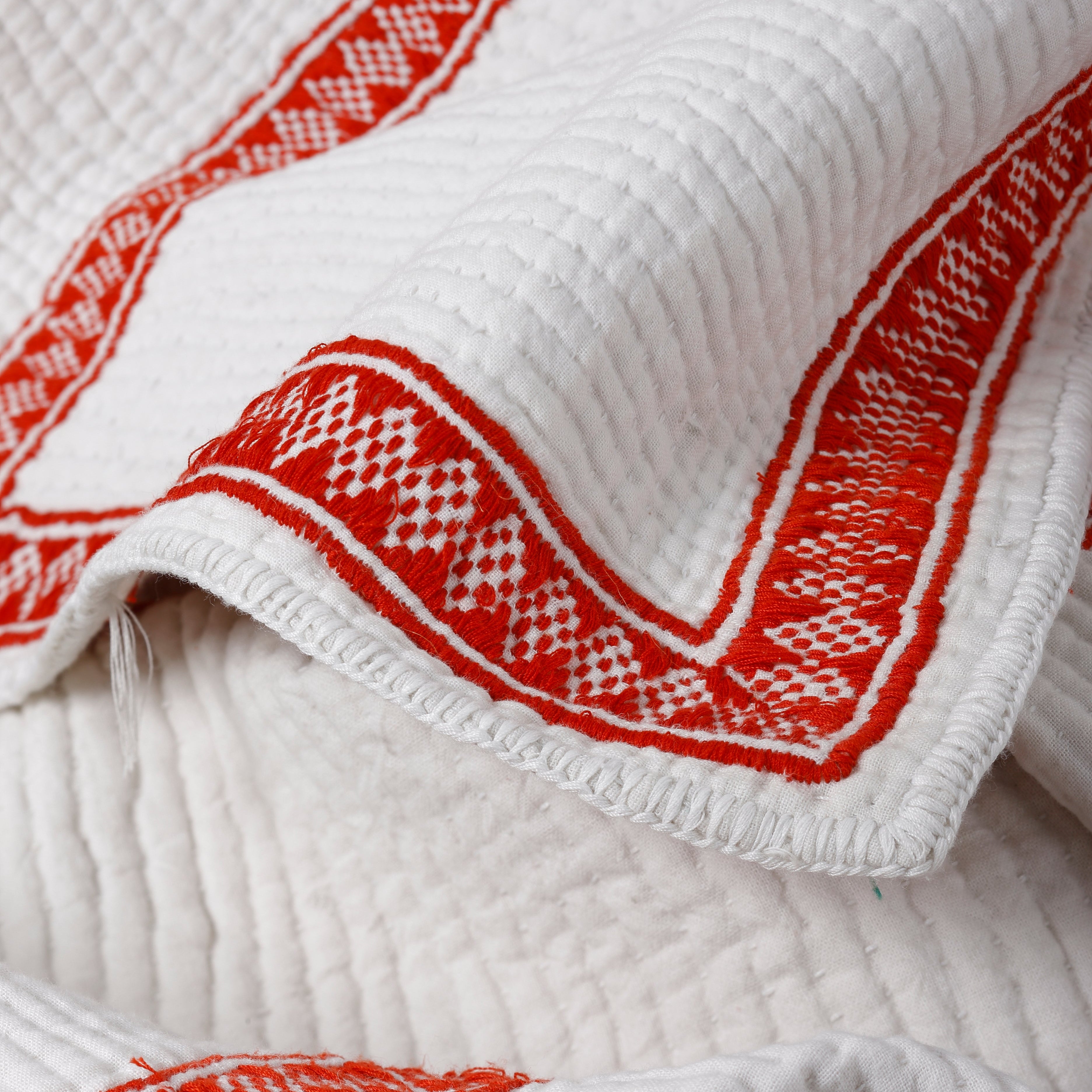 White towel with red geometric patterns