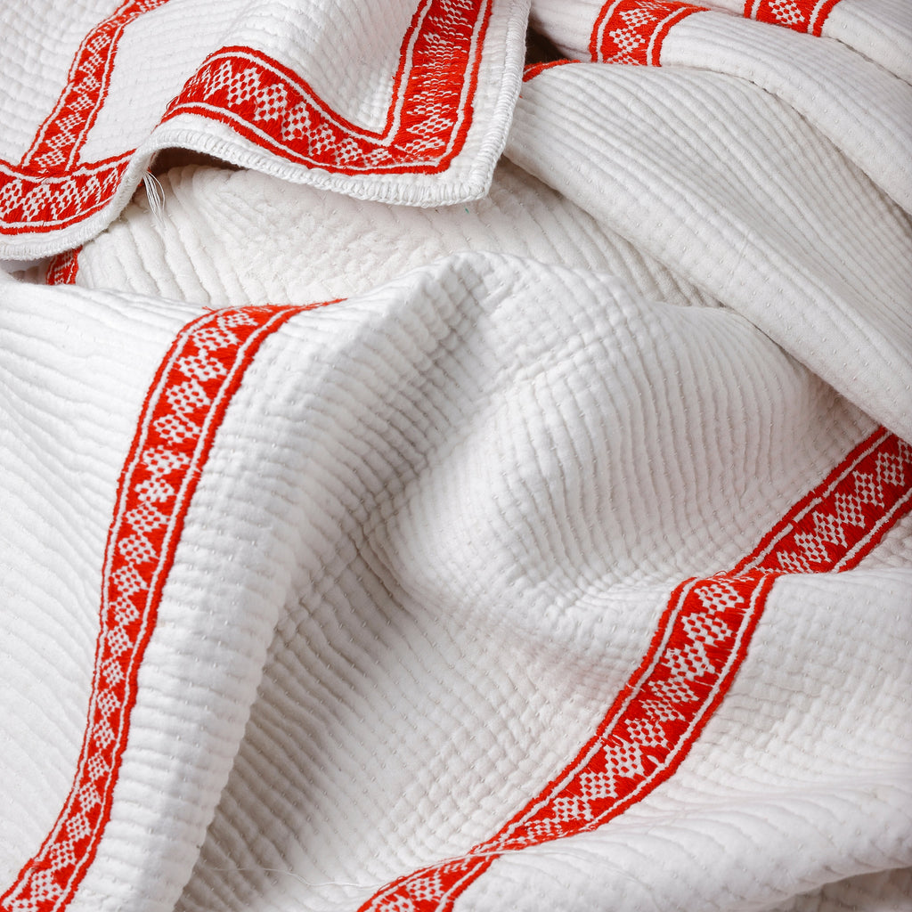 White fabric with red embroidery patterns