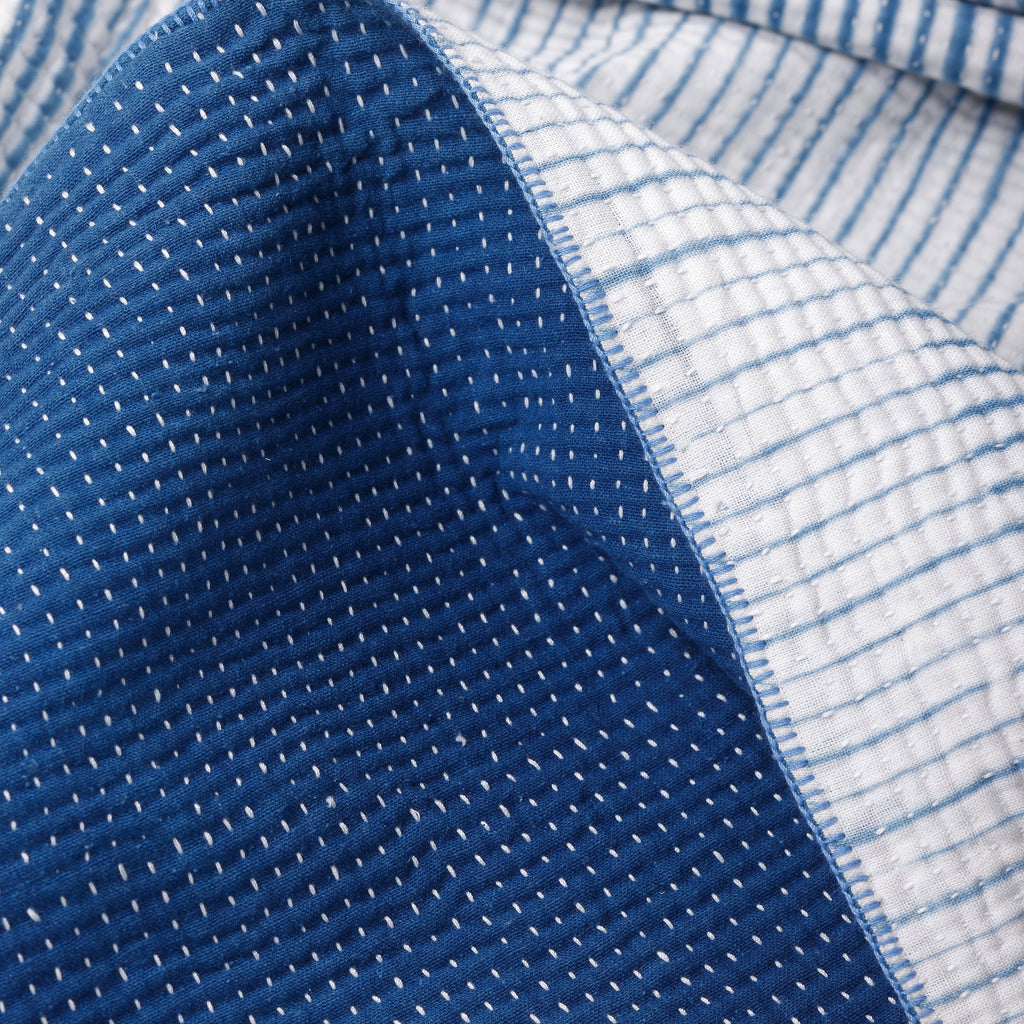 Close-up of blue and white striped fabric with textured edges