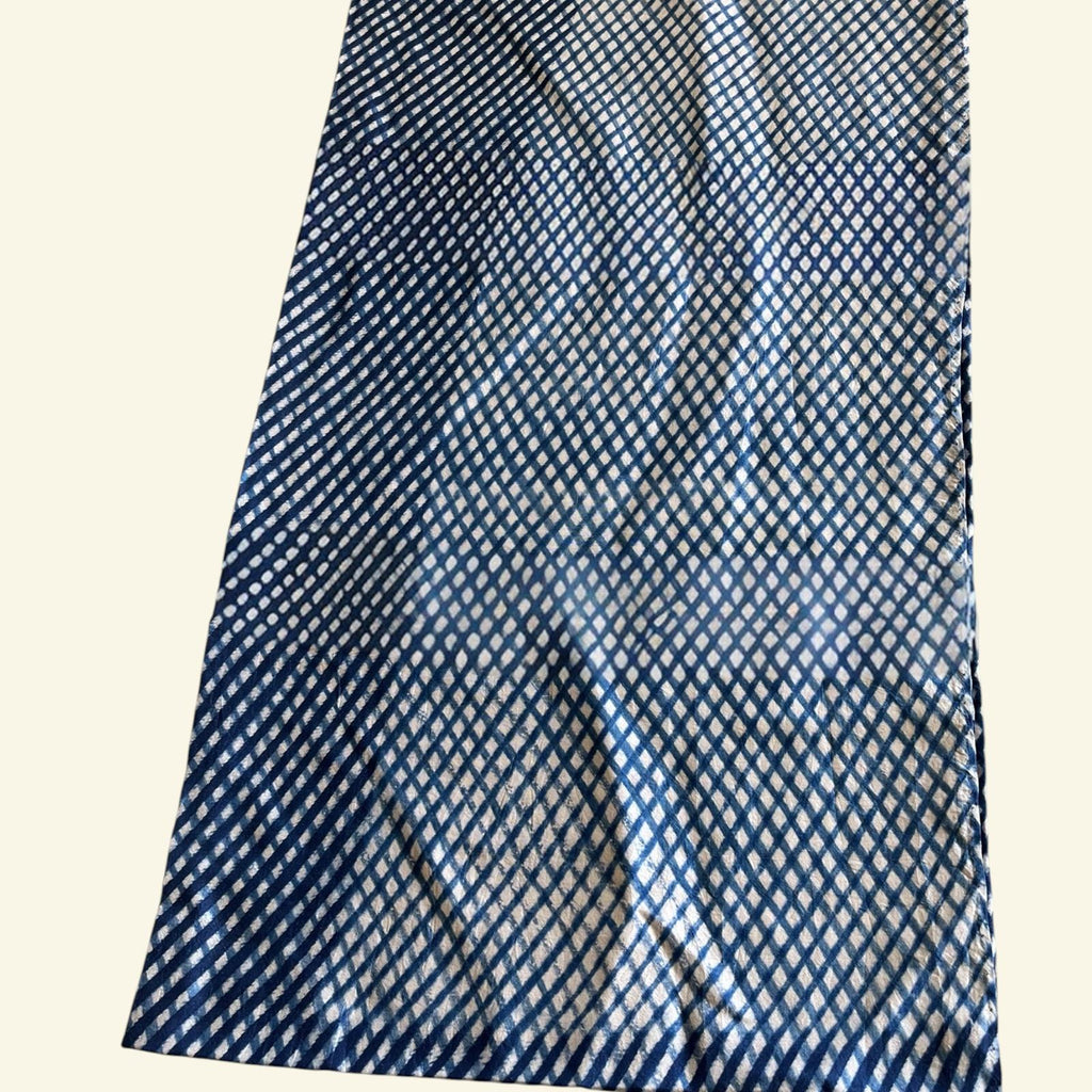 Blue and white checkered fabric on a beige background