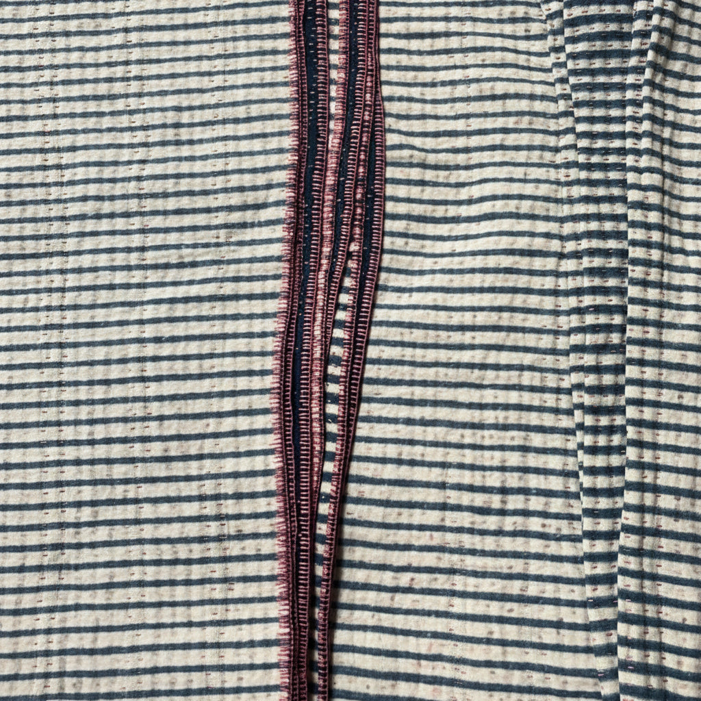 Close-up of striped fabric with a visible seam