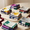 Stacks of folded fabric napkins on a wooden surface